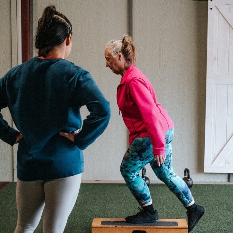 Personal training, woman doing box step ups